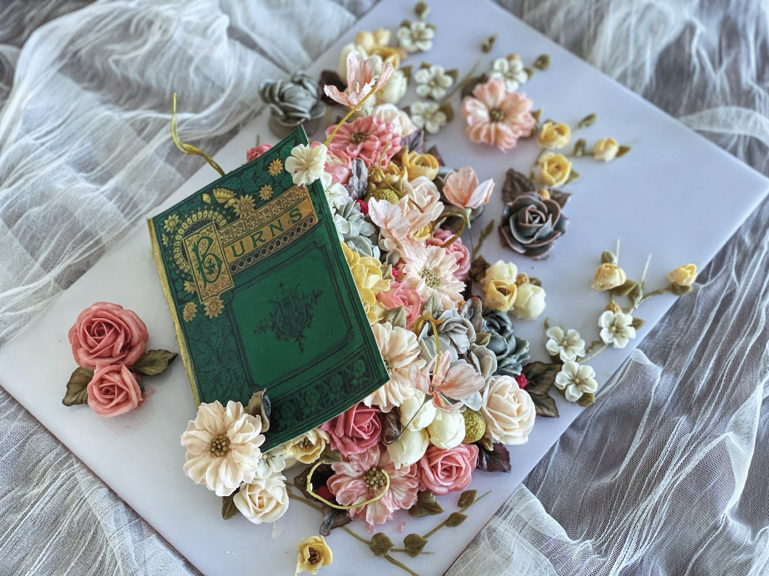 Book shaped cake decorated with buttercream flowers