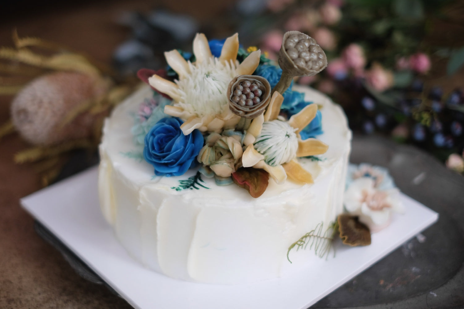 White cake with blue toned floral details
