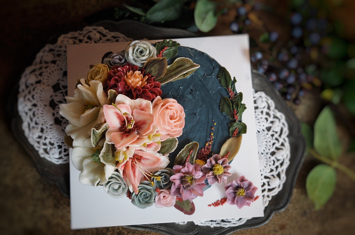 Dark blue cake with vibrant floral design